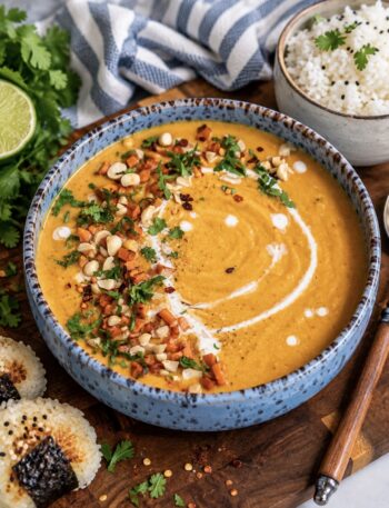 Roasted Sweet Potato Soup served in a bowl with rice.