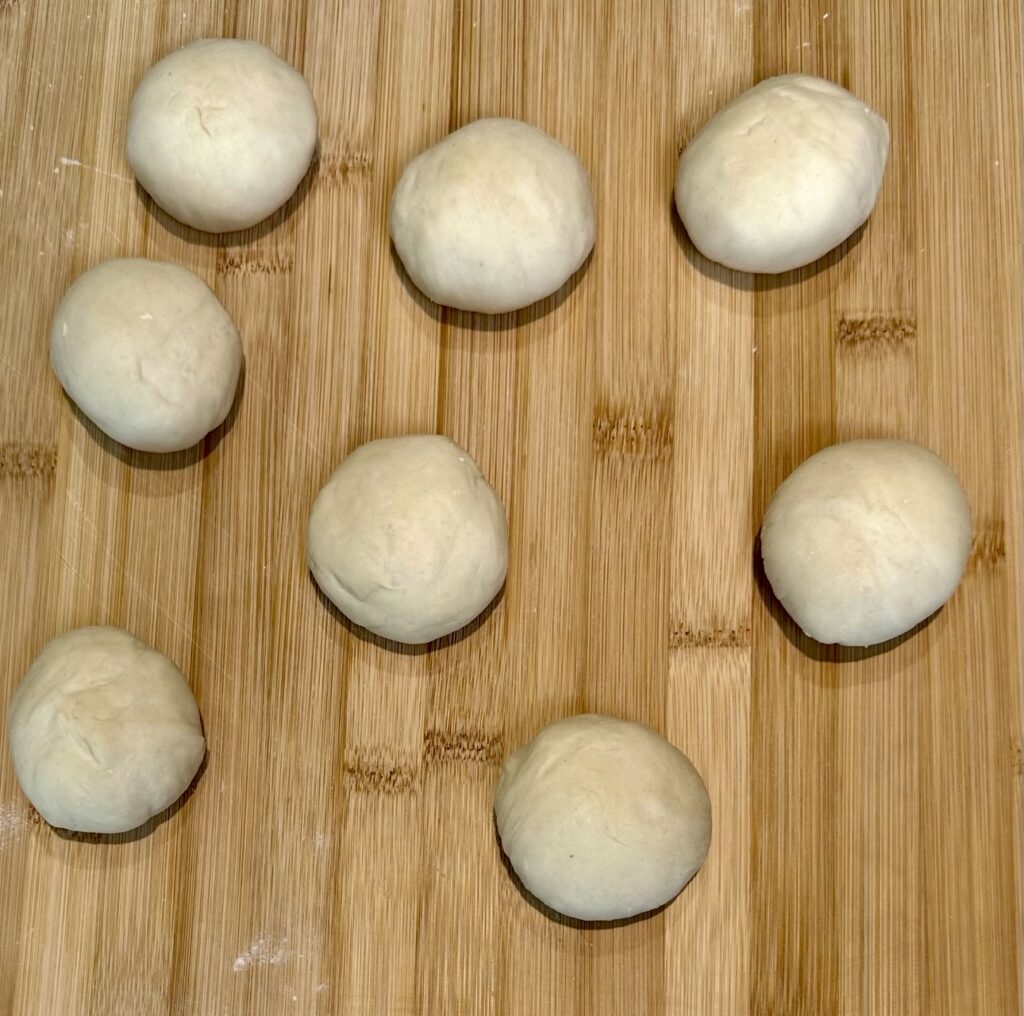 Eight dough balls for Azerbaijani Qutab on a wooden board