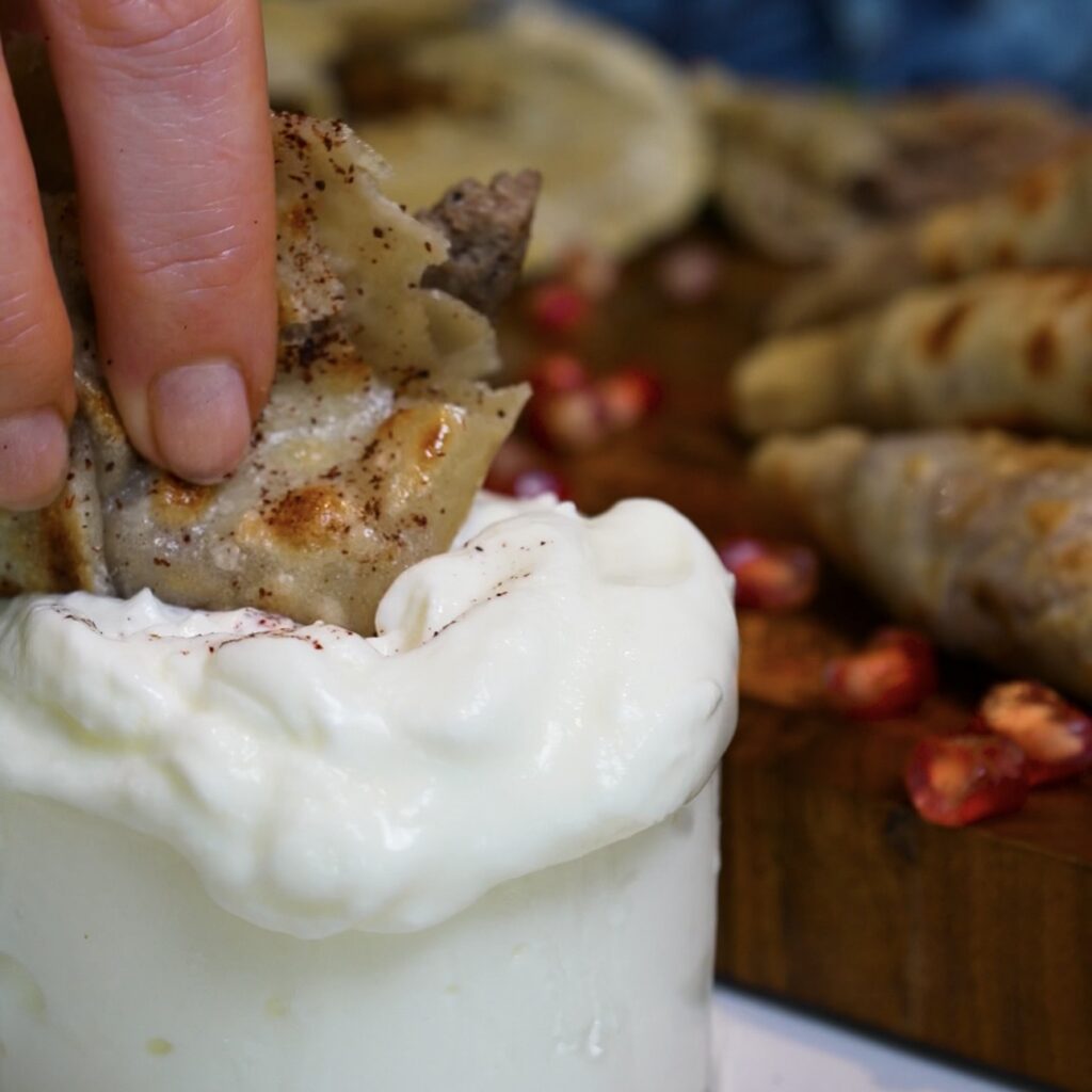 Dipping Azerbaijani Qutab into plain yoghurt