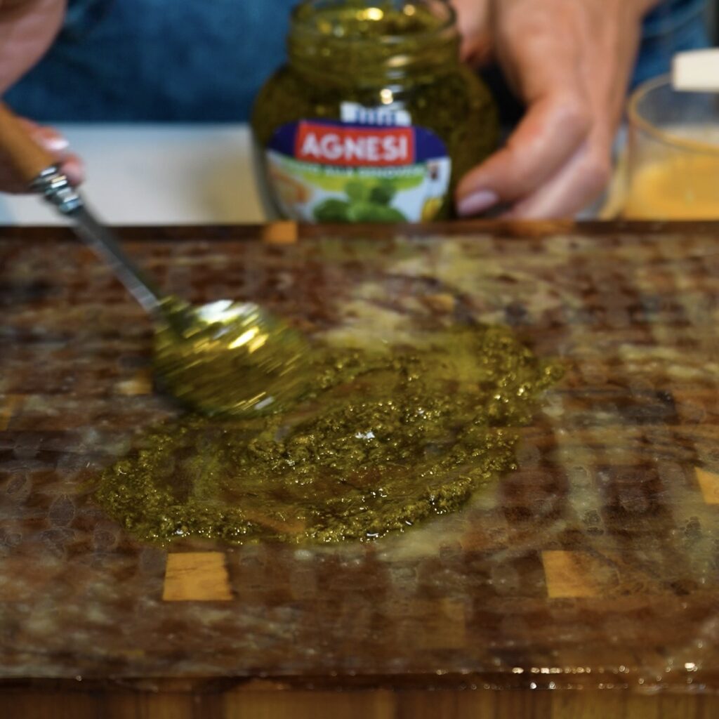 Spreading basil pesto over rice paper for Pesto Parmesan Rice Paper Twists