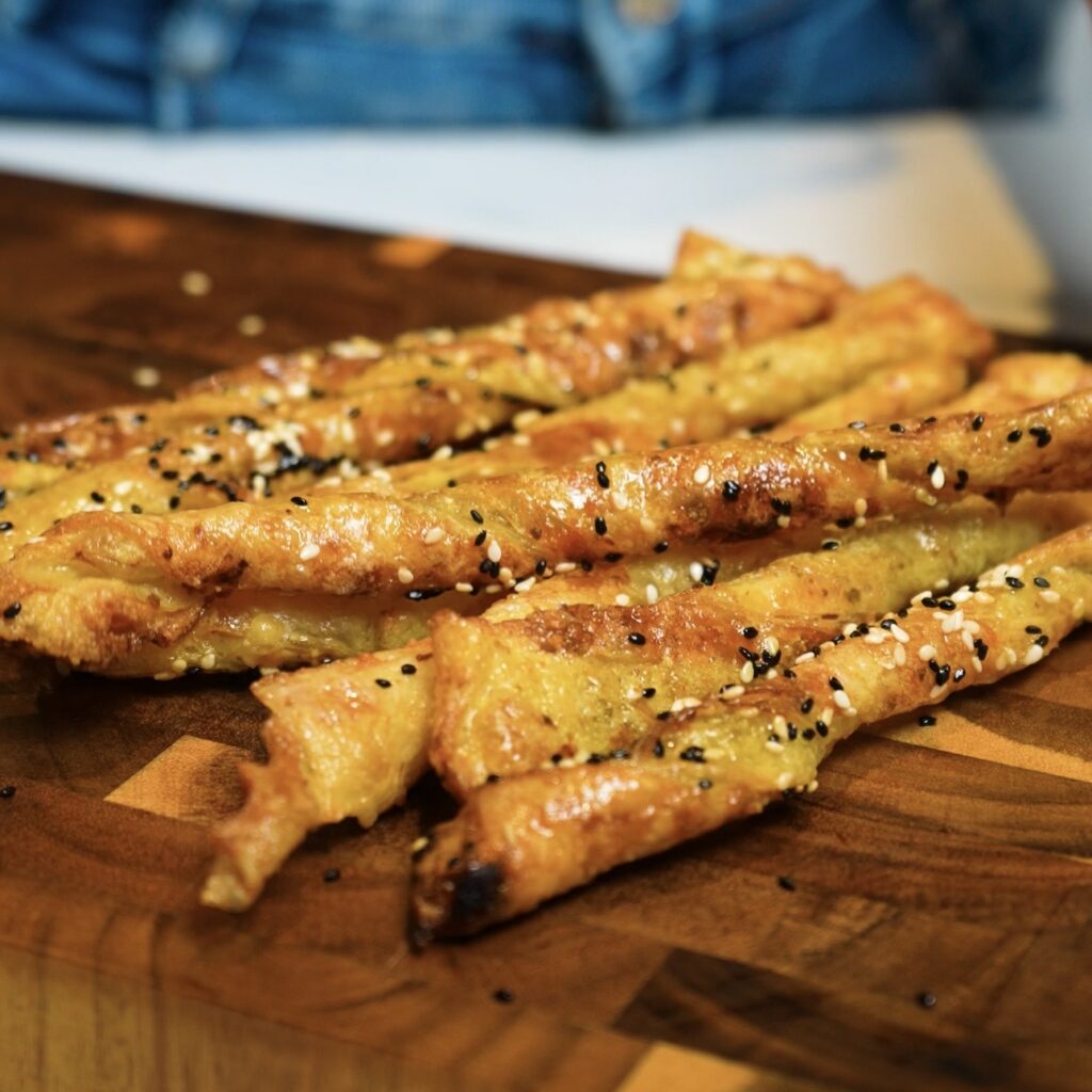 Freshly air-fried Pesto Parmesan Rice Paper Twists, golden and crispy