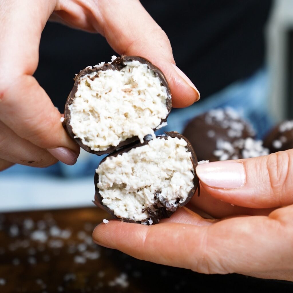 Banana Coconut Truffle cut in half showing the creamy coconut filling