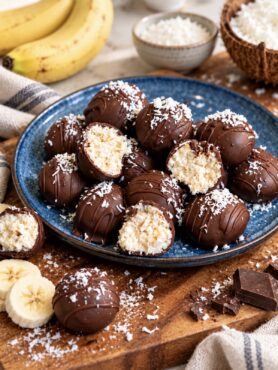 Banana Coconut Truffles served on a plate with some cut in half to show the creamy centre