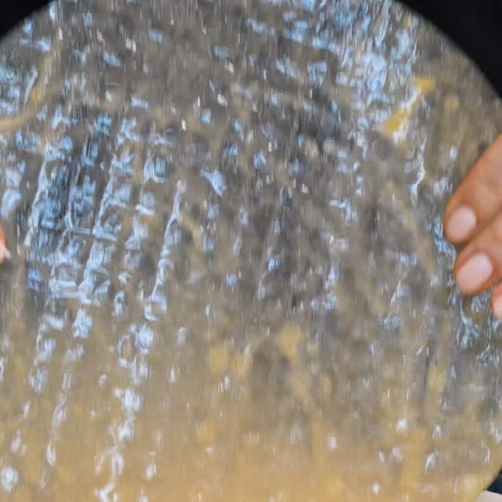 Dipping a rice paper sheet into the egg and milk mixture
