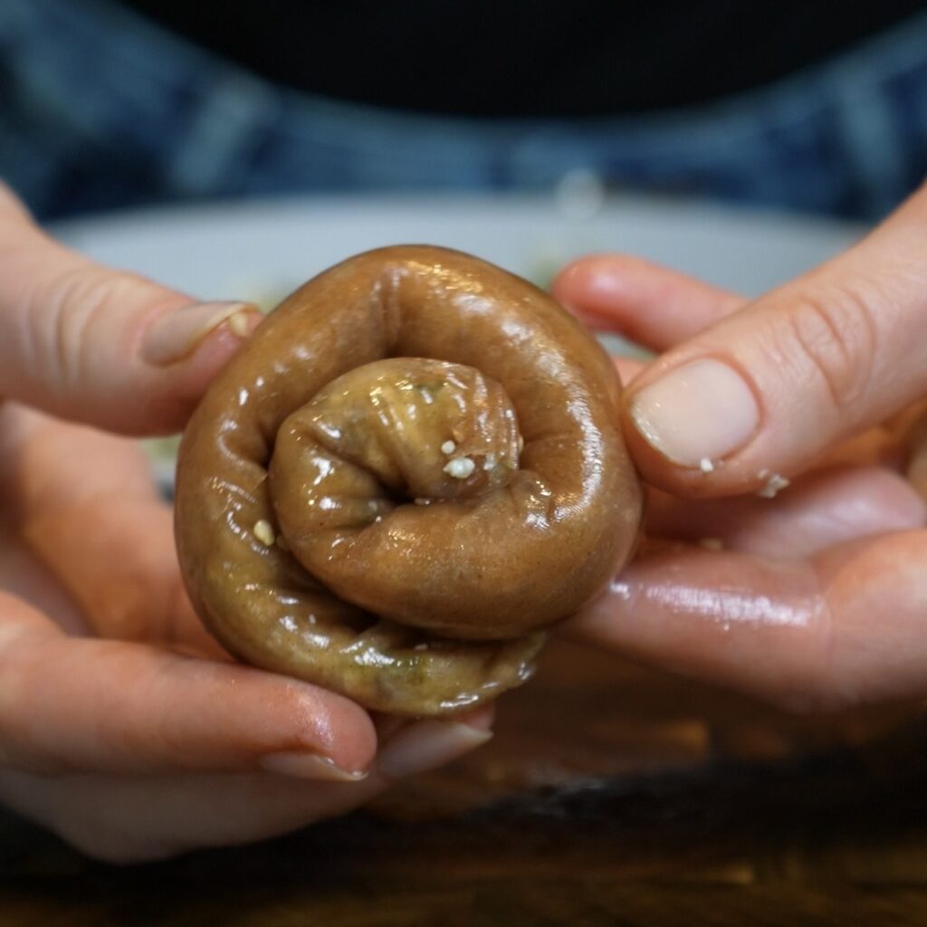 Aubergine and feta rice paper roll shaped into a spiral
