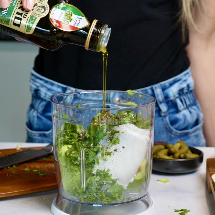 Avocado, Greek-style yoghurt, fresh coriander, lime juice and seasonings in a food processor, ready to blend into a creamy avocado yoghurt dip.