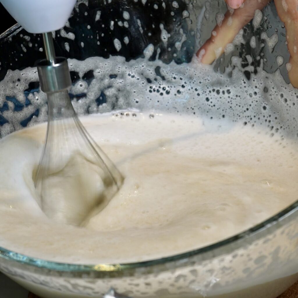 Whisking pear purée and gelatine with an electric mixer until light and fluffy for Pear Cloud Cubes with Cinnamon Filling.Cinnamon Filling.