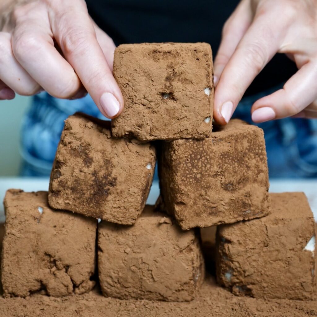 Pear Cloud Cubes coated in unsweetened cocoa powder, creating a delicate chocolatey finish for the fluffy pear dessert.