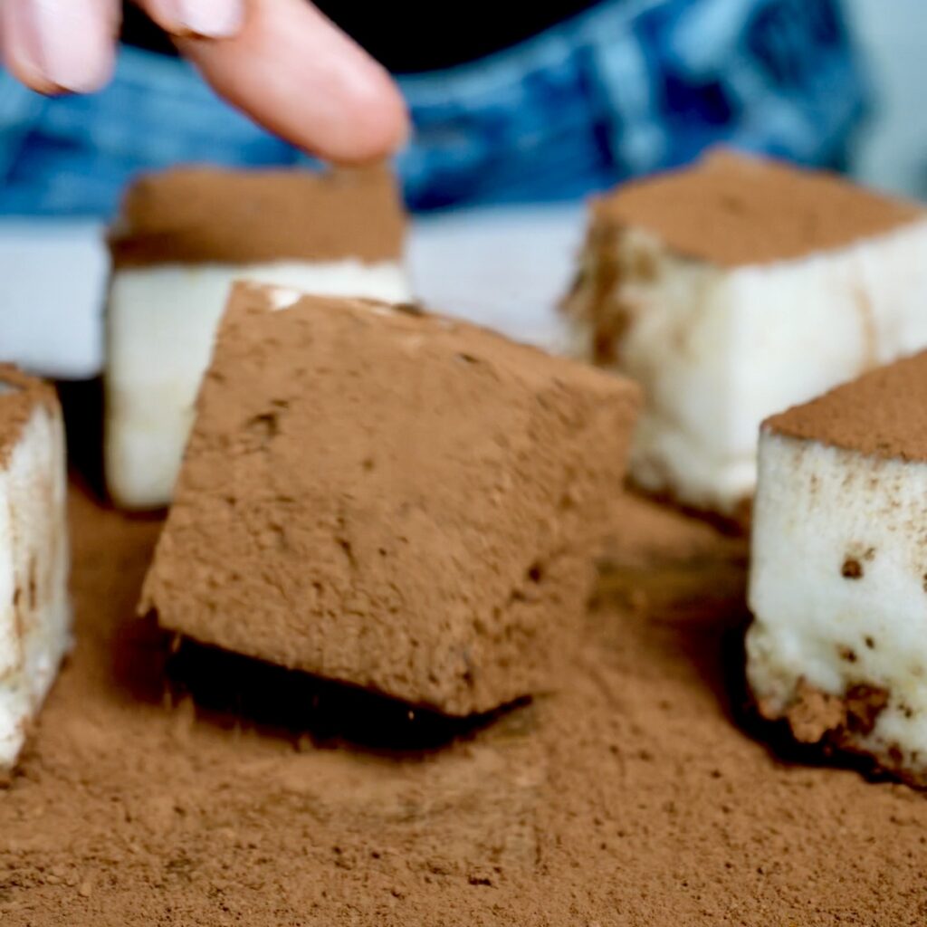 Pear Cloud Cubes coated in unsweetened cocoa powder, creating a delicate chocolatey finish for the fluffy pear dessert.