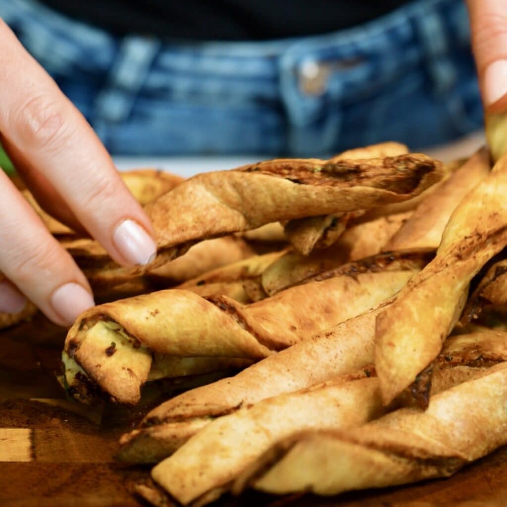 Golden crispy chicken tortilla twists fresh from the air fryer, cooked until crunchy and lightly browned.