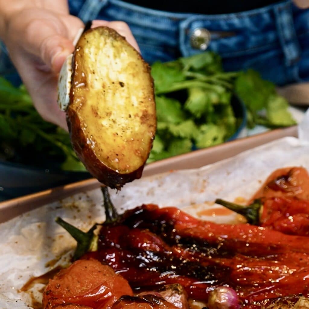 Roasted vegetables straight from the oven, showing beautifully caramelised sweet potato.