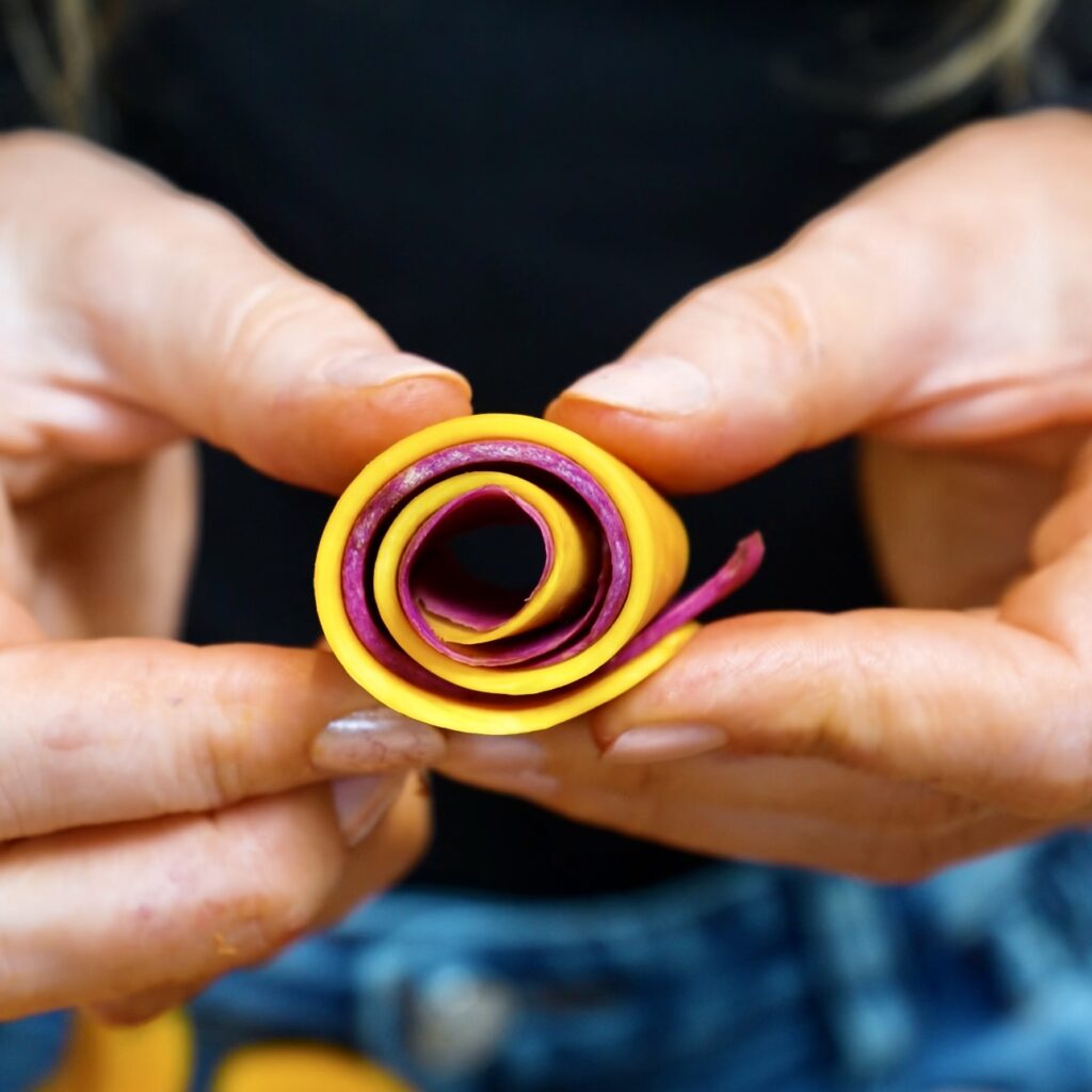 Butternut squash and purple sweet potato strips rolled into a spiral for the centre of the gratin.